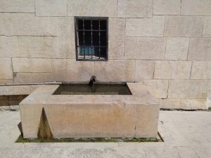 Small, stone, container, full of water at the Lavadora del Pilar.